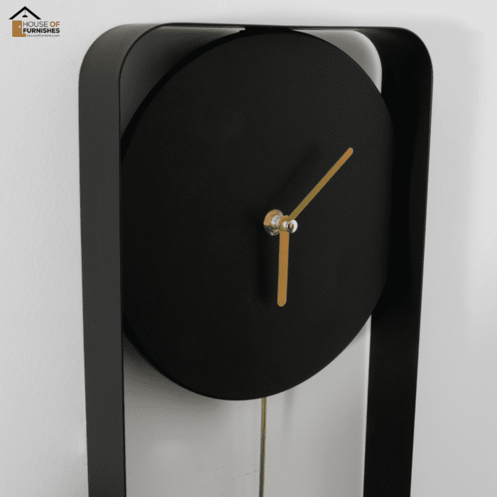 Close-up of Matte Black Metal Wall Clock with Gold Details