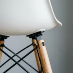 Stackable white dining chairs stored in a stack — space-saving DSW design