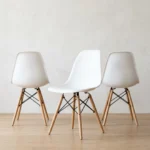 White dining chairs — Eames DSW style front view, stackable molded side chair